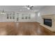 Spacious living room with hardwood floors, fireplace, and plenty of natural light at 1512 Piazzo Ct, Apex, NC 27502