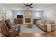 Light filled living room featuring hardwood floors, plush seating, and a fireplace at 1512 Piazzo Ct, Apex, NC 27502