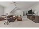 Cozy living room with a leather sofa, accent chair, built-in shelving, and a television at 1512 Piazzo Ct, Apex, NC 27502