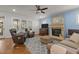 Cozy living room with hardwood floors, a fireplace, comfortable seating, and natural light at 1512 Piazzo Ct, Apex, NC 27502