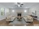Staged living room with fireplace, hardwood floors, and neutral decor at 1512 Piazzo Ct, Apex, NC 27502