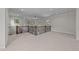 Upper loft with a decorative wrought iron railing and neutral colored carpet and multiple windows at 1512 Piazzo Ct, Apex, NC 27502