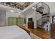 Bedroom with a spiral staircase leading to a loft, hardwood floors, and neutral walls at 1512 Piazzo Ct, Apex, NC 27502