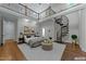 Staged main bedroom with spiral staircase, plush bedding, and a view to the second-floor balcony at 1512 Piazzo Ct, Apex, NC 27502