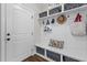 Mudroom with built-in storage bench, coat hooks and cubbies, providing organization at the entry at 1512 Piazzo Ct, Apex, NC 27502