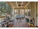 Relaxing screened porch with comfortable seating and wood floors and ceiling at 1512 Piazzo Ct, Apex, NC 27502