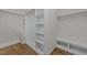 Well-organized walk-in closet with shelving, hanging rods, and built-in bench at 1512 Piazzo Ct, Apex, NC 27502