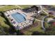 Overhead view of a pool area with plenty of lounge chairs and a community clubhouse at 1572 Bright Coral Trl, Wendell, NC 27591