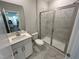 Modern bathroom featuring a glass-enclosed shower and white marble patterned tile at 1572 Bright Coral Trl, Wendell, NC 27591