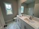 Bathroom featuring double sinks, marble flooring and a view from the window at 1572 Bright Coral Trl, Wendell, NC 27591