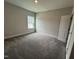 Neutral bedroom with plush carpeting, a window and fresh paint at 1572 Bright Coral Trl, Wendell, NC 27591