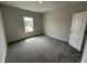 Bedroom with plush carpeting, a window and a door at 1572 Bright Coral Trl, Wendell, NC 27591