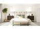 Serene bedroom featuring neutral tones, decorative plants, and modern decor at 1572 Bright Coral Trl, Wendell, NC 27591