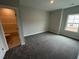 Carpeted bedroom with a window, ensuite bathroom and neutral paint at 1572 Bright Coral Trl, Wendell, NC 27591