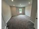 Neutral bedroom with plush carpeting and a window at 1572 Bright Coral Trl, Wendell, NC 27591