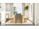 Bright dining space with wood table, modern decor, and a view through the large window at 1572 Bright Coral Trl, Wendell, NC 27591