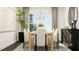 Dining area featuring a wood table, upholstered chairs, chandelier, and neutral decor at 1572 Bright Coral Trl, Wendell, NC 27591