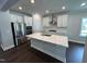 Modern kitchen boasts white cabinets, a center island, stainless steel appliances, and sleek countertops at 1572 Bright Coral Trl, Wendell, NC 27591