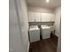 Bright laundry room with white cabinets and appliances at 1572 Bright Coral Trl, Wendell, NC 27591