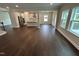 Spacious living area with hardwood floors leading into a kitchen and dining area, filled with natural light at 1572 Bright Coral Trl, Wendell, NC 27591