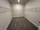 Spacious walk-in closet with carpet flooring and wire shelving at 1572 Bright Coral Trl, Wendell, NC 27591