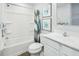 Bright bathroom with tub and shower combination, framed art, and a single sink vanity at 161 Sunny Acres Rd, Garner, NC 27603