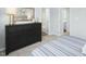 Stylish bedroom featuring a comfortable bed, a large mirror, and easy access to ensuite bathrooms at 161 Sunny Acres Rd, Garner, NC 27603