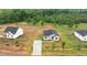 Overhead shot of a home, nestled among lush trees, boasting a clean driveway and well-manicured lawn at 170 Brookhaven Dr, Spring Hope, NC 27882