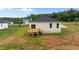 A spacious backyard showing a wooden deck, sliding glass door and view of the rear of the house at 170 Brookhaven Dr, Spring Hope, NC 27882