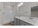 Bathroom showcasing a double sink vanity and tiled shower at 170 Brookhaven Dr, Spring Hope, NC 27882