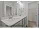 A bright bathroom features a dual sink vanity, framed mirror and access to the walk-in closet at 170 Brookhaven Dr, Spring Hope, NC 27882