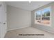 Neutral bedroom with a large window, plush carpeting, and a closet perfect for storage at 170 Brookhaven Dr, Spring Hope, NC 27882