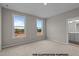 Cozy bedroom with two large windows providing ample natural light and plush carpeting at 170 Brookhaven Dr, Spring Hope, NC 27882