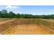 An elevated and open deck perfect for outdoor relaxation or entertaining with beautiful trees in the background at 170 Brookhaven Dr, Spring Hope, NC 27882