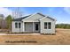 Charming single story home with black door, complementary landscaping and neutral siding at 170 Brookhaven Dr, Spring Hope, NC 27882