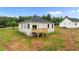 Rear exterior view of a bright home featuring a deck, a sliding glass door, a basement access, and vinyl siding at 170 Brookhaven Dr, Spring Hope, NC 27882