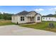 Charming one-story home with neutral siding, black front door, and a concrete driveway at 170 Brookhaven Dr, Spring Hope, NC 27882