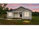 Charming one-story home featuring neutral siding, black front door and a cozy covered porch at 170 Brookhaven Dr, Spring Hope, NC 27882
