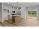 Bright kitchen featuring stainless steel appliances, granite countertops, and an island with a sink at 170 Brookhaven Dr, Spring Hope, NC 27882