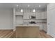 Modern kitchen with grey cabinets, granite countertops, stainless appliances, and a center island at 170 Brookhaven Dr, Spring Hope, NC 27882