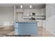 Modern kitchen featuring an island with a sink, granite countertops, white cabinetry, and stainless steel appliances at 170 Brookhaven Dr, Spring Hope, NC 27882