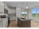Bright kitchen featuring stainless steel appliances, granite countertops, and an island with a sink at 170 Brookhaven Dr, Spring Hope, NC 27882