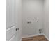 The laundry room has connections for the washer and dryer, and vinyl plank flooring at 170 Brookhaven Dr, Spring Hope, NC 27882