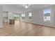 Open-concept living room with LVP flooring, ceiling fan and large windows allowing lots of natural light at 170 Brookhaven Dr, Spring Hope, NC 27882