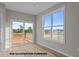 Bright living room featuring large windows, sliding glass doors to the deck, and light wood floors at 170 Brookhaven Dr, Spring Hope, NC 27882