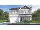 Charming two-story home with stone accents and a covered front porch at 174 W Saint Andrews Dr, Zebulon, NC 27597