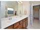 Dual sinks, white countertop, and wood cabinets highlight this spacious bathroom at 1914 Woodsdale Dr, Durham, NC 27703