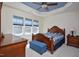 The bedroom offers a tray ceiling, natural light, and an upholstered storage bench at 1914 Woodsdale Dr, Durham, NC 27703