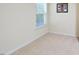 The bedroom is a blank slate with carpet and window for natural light at 1914 Woodsdale Dr, Durham, NC 27703