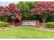 Brightleaf at the Park sign surrounded by vibrant pink trees, and manicured lawn at 1914 Woodsdale Dr, Durham, NC 27703